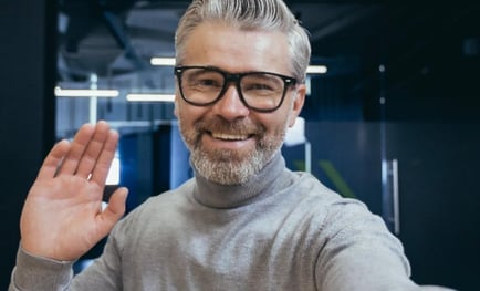 a person with glasses smiling 